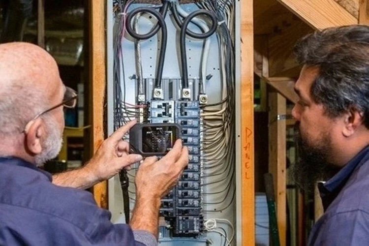 Picture of a femal Electrical Contractor taking readings from an electrical circuit