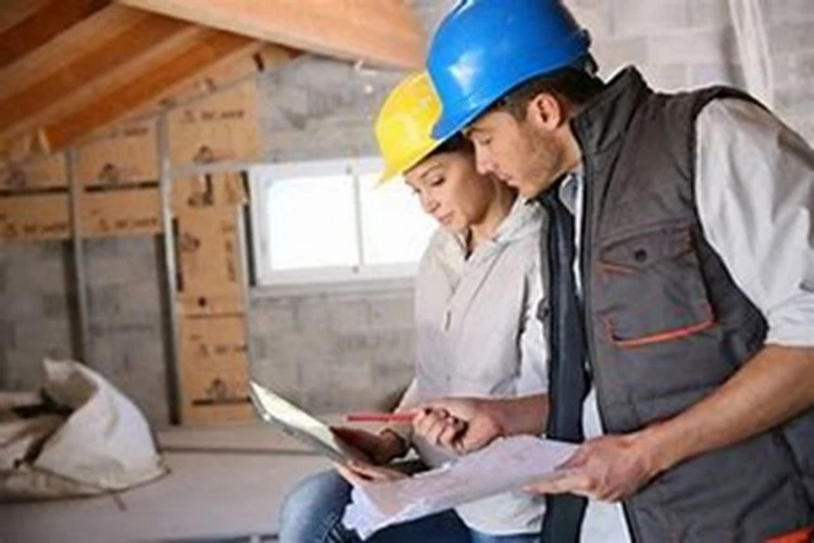 Picture of a Home Inspector reviewing report with customer