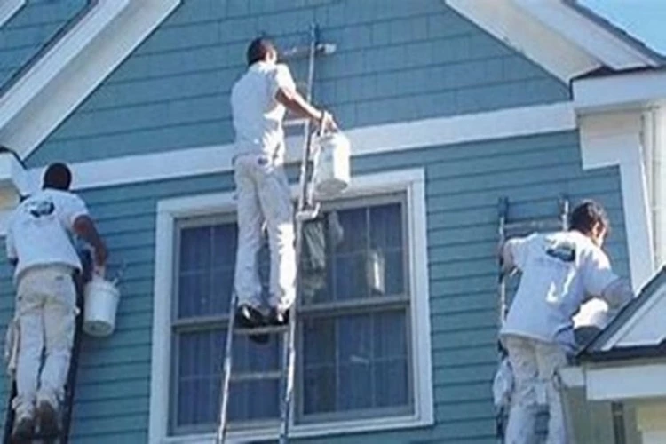 Picture of three Painting Contractors painting the gable end of a home and the trim of the gable